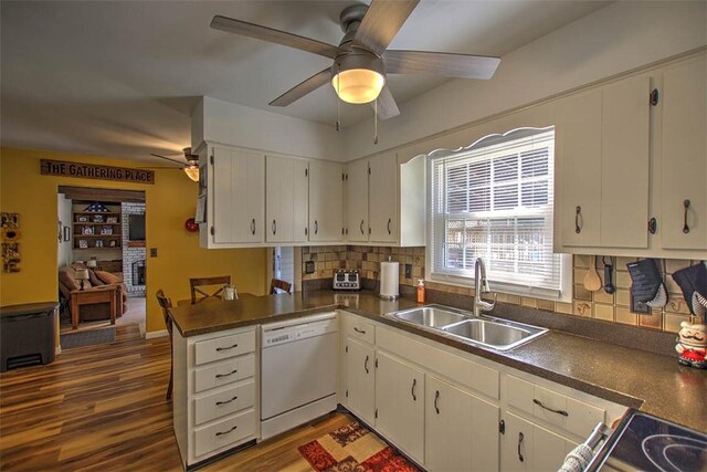 940 Kirk Dr, Mt Zion, IL 62549 - kitchen featuring white dishwasher, ceiling fan, dark countertops, tasteful backsplash, and dark wood-type flooring