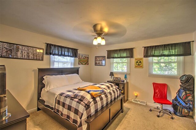 940 Kirk Dr, Mt Zion, IL 62549 - bedroom with multiple windows, light carpet, and a ceiling fan