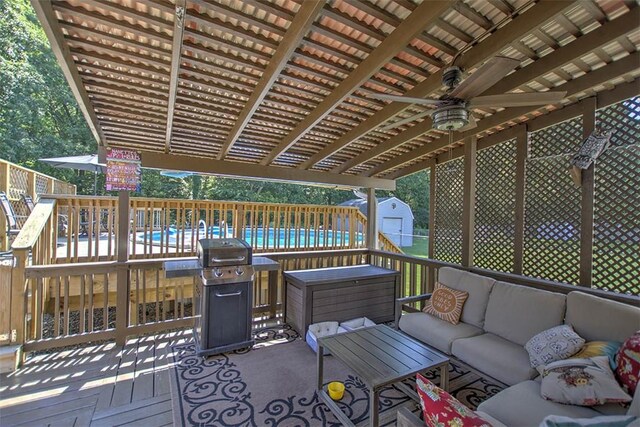 940 Kirk Dr, Mt Zion, IL 62549 - deck with an outdoor hangout area, a storage unit, a ceiling fan, and a grill