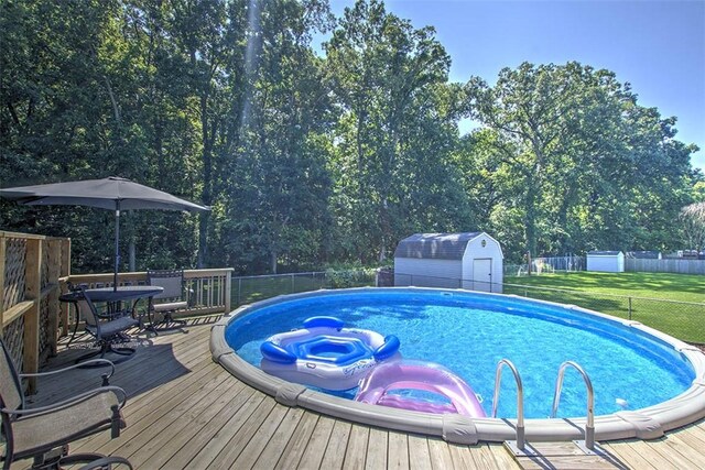 940 Kirk Dr, Mt Zion, IL 62549 - view of pool with a deck, a shed, and outdoor dining area