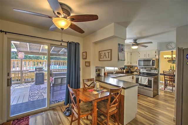 940 Kirk Dr, Mt Zion, IL 62549 - dining space featuring ceiling fan and wood finished floors