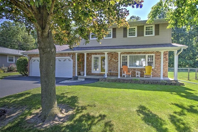 940 Kirk Dr, Mt Zion, IL 62549 - traditional home with driveway, an attached garage, brick siding, and covered porch