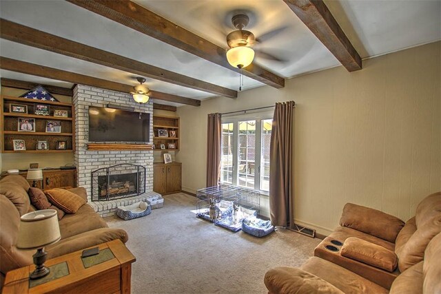 940 Kirk Dr, Mt Zion, IL 62549 - living area with a ceiling fan, beam ceiling, carpet floors, and a fireplace