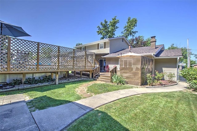 940 Kirk Dr, Mt Zion, IL 62549 - back of property featuring a wooden deck, a yard, and a chimney