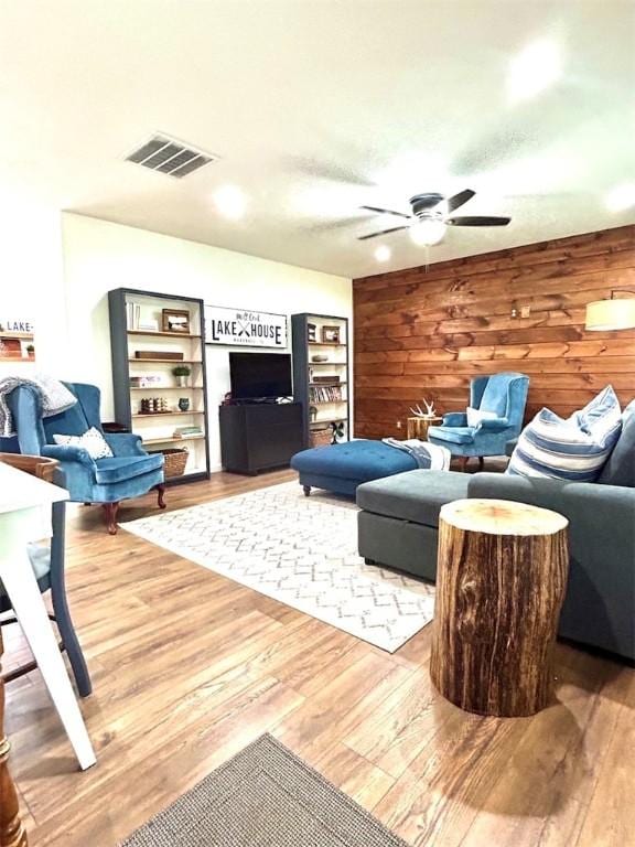 20786 Heritage Ln, Marshall, IL 62441 - living area with wooden walls, visible vents, ceiling fan, and wood finished floors