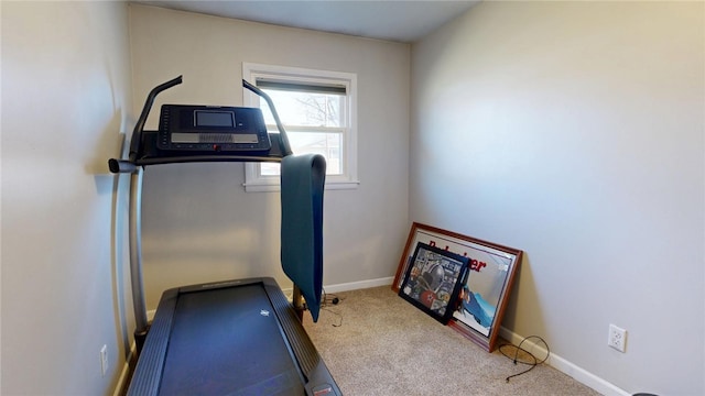 exercise room featuring carpet flooring and baseboards