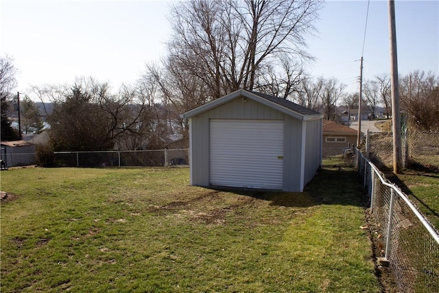 detached garage with fence and a shed