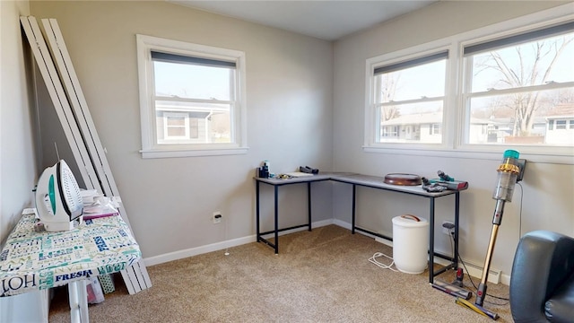 office space featuring carpet flooring, plenty of natural light, and baseboards