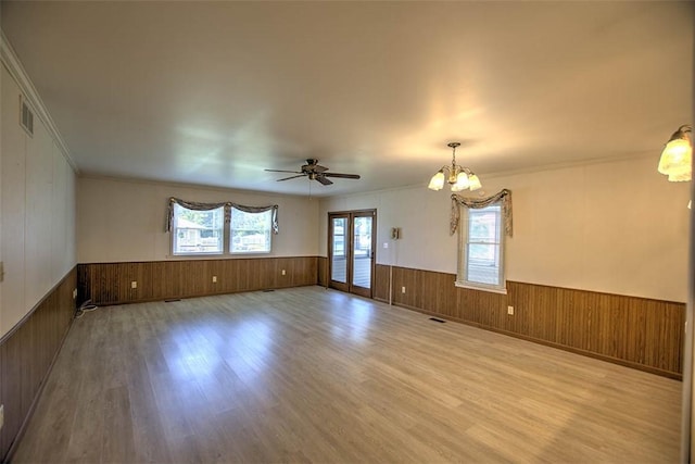 3204 Meadow Ln, Decatur, IL 62521 - spare room featuring wainscoting, wood walls, wood finished floors, a chandelier, and ornamental molding