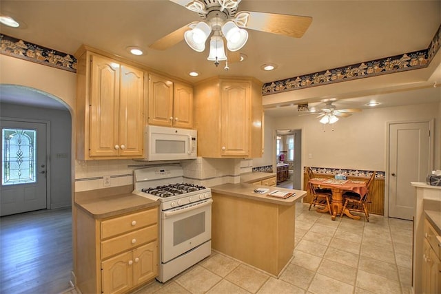 3204 Meadow Ln, Decatur, IL 62521 - kitchen featuring white appliances, ceiling fan, light brown cabinets, recessed lighting, and arched walkways