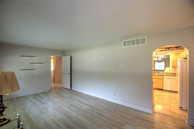 3204 Meadow Ln, Decatur, IL 62521 - unfurnished living room with arched walkways and light wood finished floors