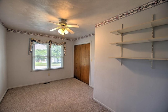 3204 Meadow Ln, Decatur, IL 62521 - unfurnished bedroom with light colored carpet, a closet, and a ceiling fan
