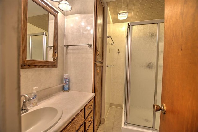 3204 Meadow Ln, Decatur, IL 62521 - full bathroom with a shower stall, vanity, tile patterned floors, and tile walls