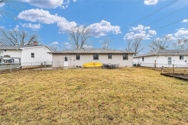 back of property with a fenced backyard and a yard