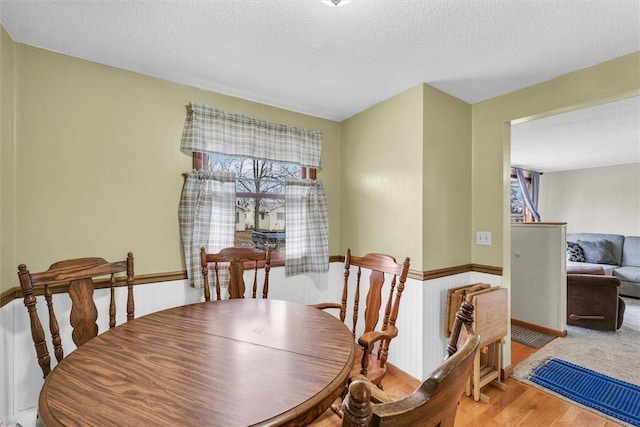 dining area featuring baseboards and a textured ceiling