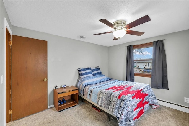 bedroom with visible vents, a baseboard heating unit, carpet flooring, ceiling fan, and a textured ceiling