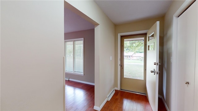 entryway featuring hardwood / wood-style floors and baseboard heating