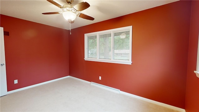 carpeted empty room featuring baseboard heating and ceiling fan