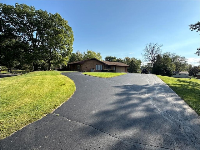 view of front of house featuring a garage and a front lawn