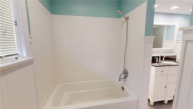 bathroom with vanity and tiled shower / bath combo