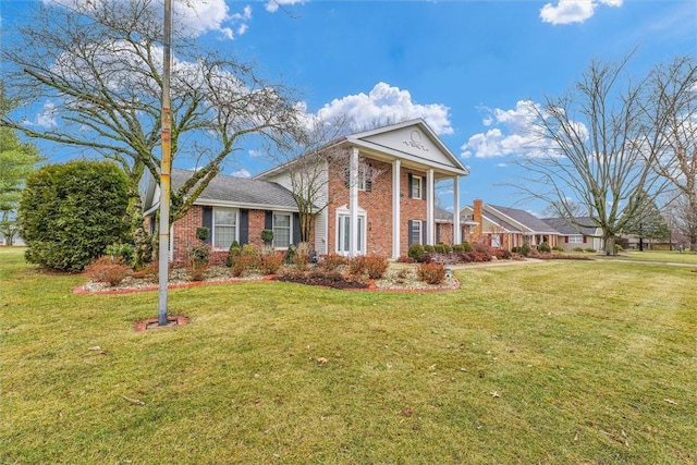 greek revival house featuring a front lawn