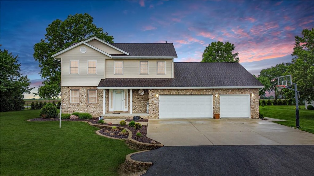 3 Country Club Ests, Sullivan, IL 61951 - traditional-style home featuring brick siding, a garage, a lawn, and driveway