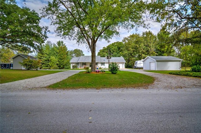 9234 E Cabin Rd, Oakley, IL 62501 - ranch-style house featuring a front lawn, an outbuilding, and driveway