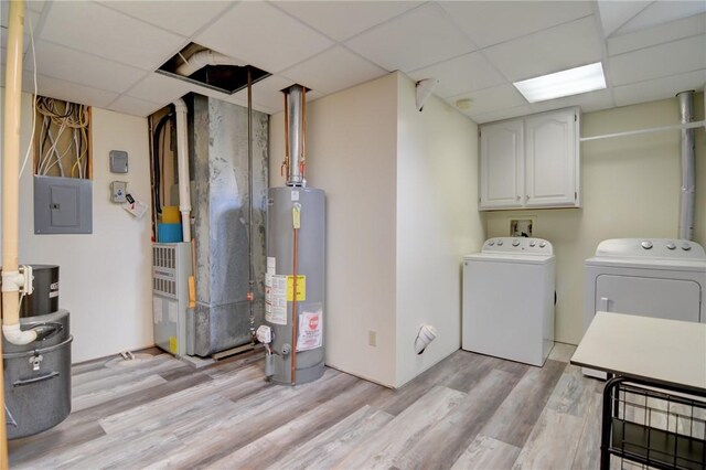 9234 E Cabin Rd, Oakley, IL 62501 - laundry room featuring gas water heater, electric panel, light wood-style flooring, cabinet space, and separate washer and dryer