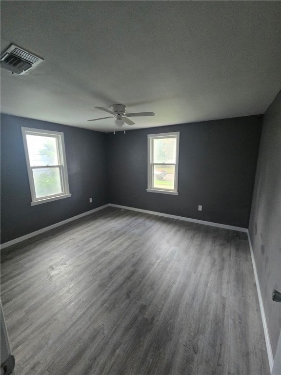 1809 E Decatur St, Decatur, IL 62521 - spare room featuring wood finished floors, healthy amount of natural light, baseboards, and a ceiling fan