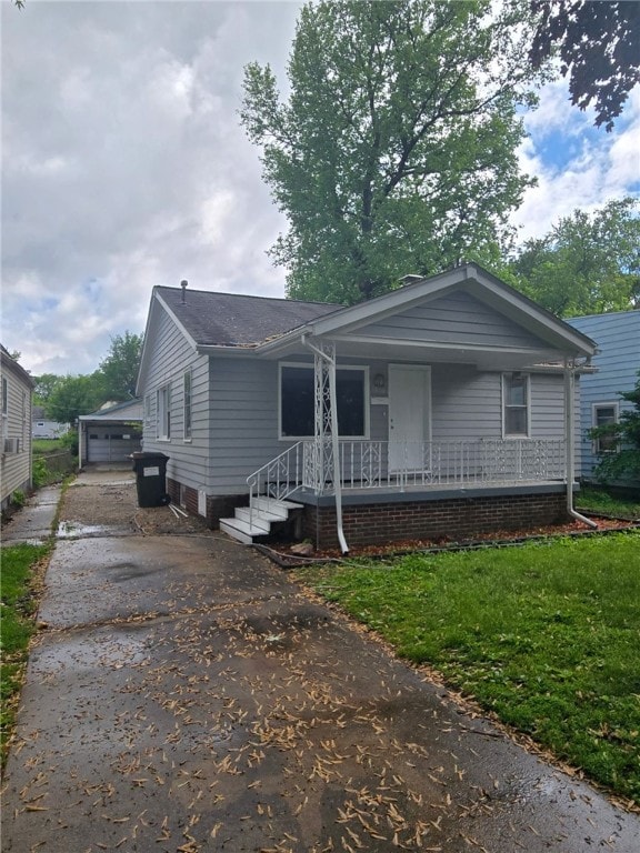 1809 E Decatur St, Decatur, IL 62521 - view of front of property featuring covered porch, driveway, and a detached garage
