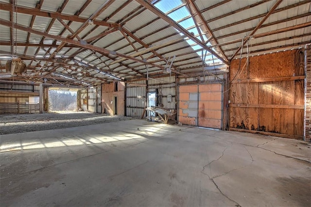 miscellaneous room with high vaulted ceiling and concrete floors