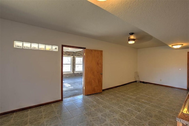 unfurnished room with a textured ceiling