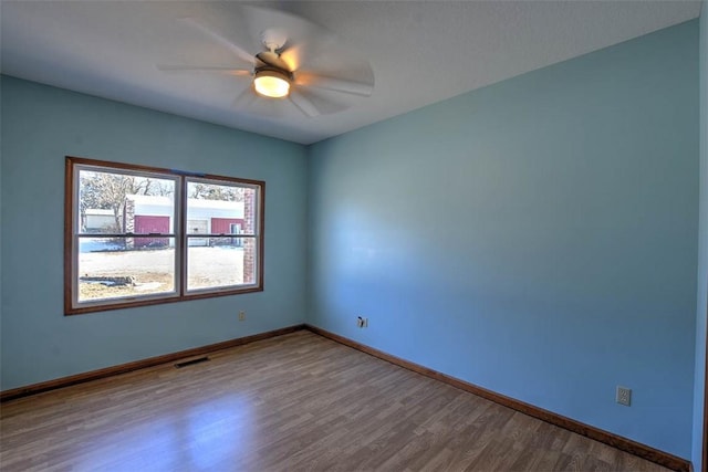 unfurnished room featuring ceiling fan and hardwood / wood-style floors