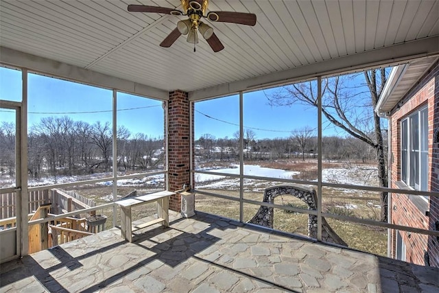 unfurnished sunroom with ceiling fan and a wealth of natural light