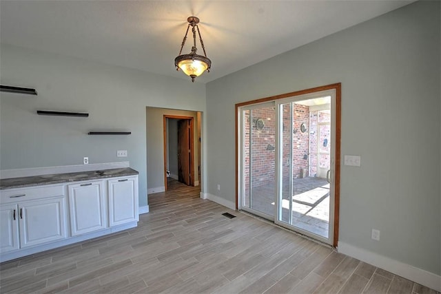 unfurnished dining area featuring light hardwood / wood-style flooring