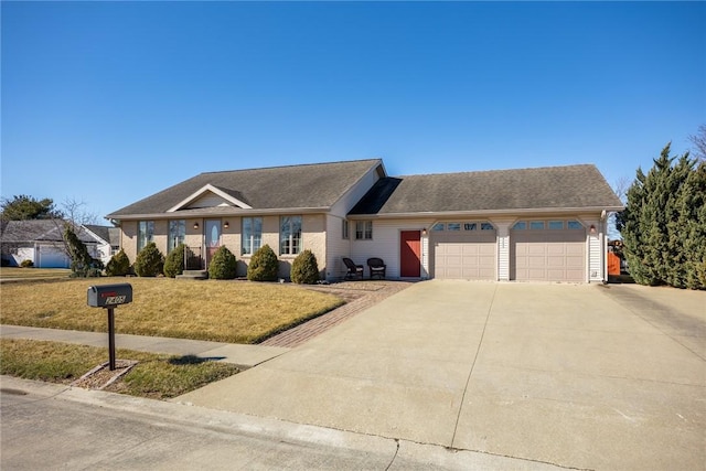 single story home featuring an attached garage, a front lawn, and concrete driveway