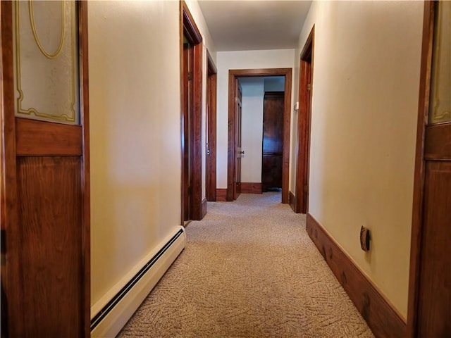 1622 S Cross St, Robinson, IL 62454 - hallway featuring a baseboard radiator, light colored carpet, and baseboards