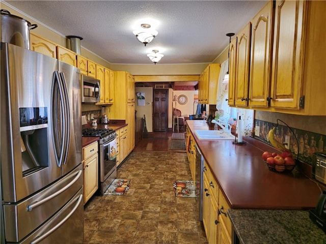 1622 S Cross St, Robinson, IL 62454 - kitchen featuring stainless steel appliances, dark countertops, a sink, a textured ceiling, and stone finish flooring