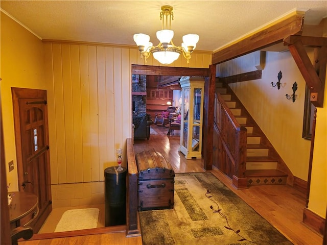 1622 S Cross St, Robinson, IL 62454 - foyer entrance featuring wood finished floors, a chandelier, stairs, crown molding, and wooden walls