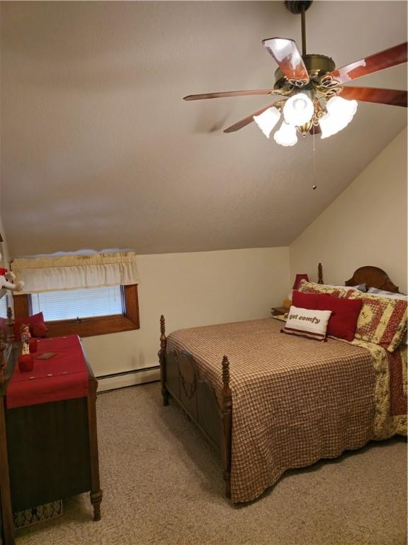 1622 S Cross St, Robinson, IL 62454 - bedroom featuring baseboard heating, carpet floors, lofted ceiling, and a ceiling fan