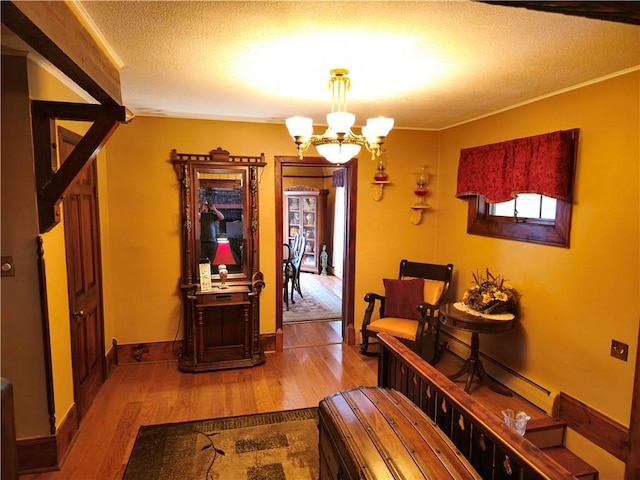 1622 S Cross St, Robinson, IL 62454 - hall featuring a chandelier, wood finished floors, a textured ceiling, and crown molding