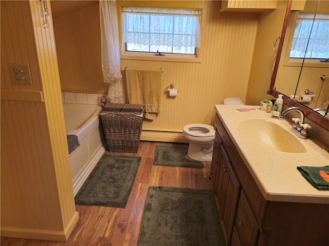 1622 S Cross St, Robinson, IL 62454 - full bathroom with wood finished floors, a baseboard heating unit, vanity, a tub, and toilet