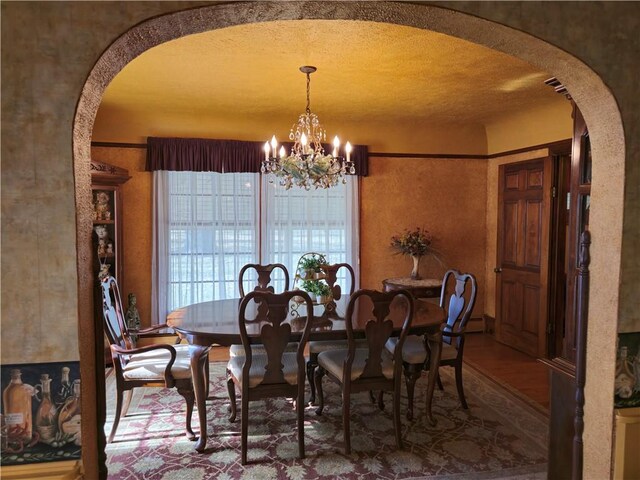 1622 S Cross St, Robinson, IL 62454 - dining room with arched walkways, a chandelier, and wood finished floors