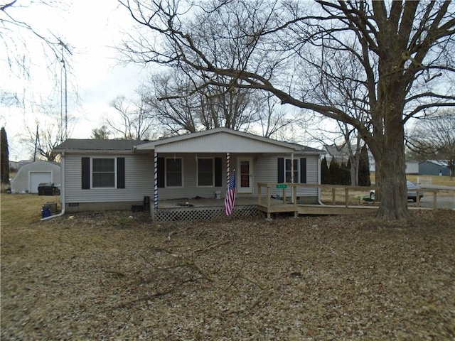 view of front facade with a porch, crawl space, and an outdoor structure