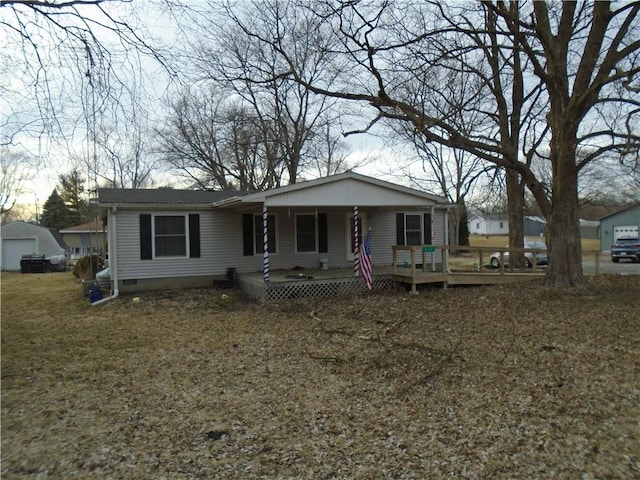 view of front facade featuring covered porch, crawl space, and a garage