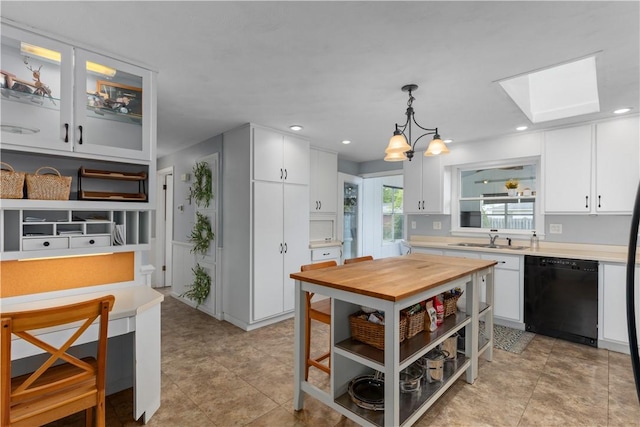 1022 Penguin St, Effingham, IL 62401 - kitchen with black dishwasher, a sink, white cabinetry, a skylight, and a chandelier