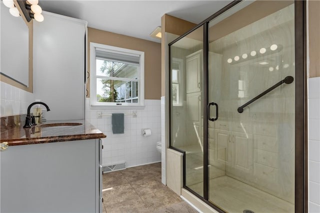 1022 Penguin St, Effingham, IL 62401 - bathroom with tile walls, tile patterned floors, a shower stall, and toilet