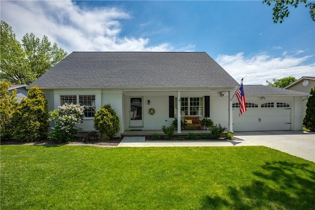 1022 Penguin St, Effingham, IL 62401 - new england style home featuring covered porch, a garage, concrete driveway, a front lawn, and brick siding