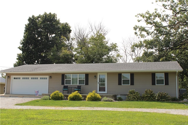 ranch-style home featuring a garage and a front lawn