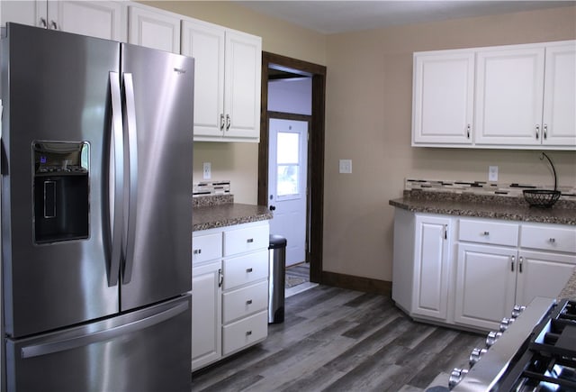 kitchen featuring stainless steel fridge, dark hardwood / wood-style flooring, and white cabinetry